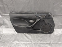 2001–2005 Mazda Miata MX-5 NB Driver Door Panel Black OEM NC10-59-590 01-05 — Mazda Miata MX-5 OEM part product photo