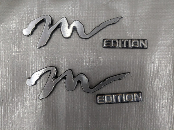 1994-1997 Mazda Miata Mx-5 OEM Silver "M Edition" Fender Badge Emblem Genuine 94-97 — Mazda Miata MX-5 OEM part product photo