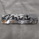 1990-1997 Mazda Miata Mx-5 OEM Rear Emblem Badge Black & Chrome NA Mk1 90-97 — Mazda Miata OEM used part product photo